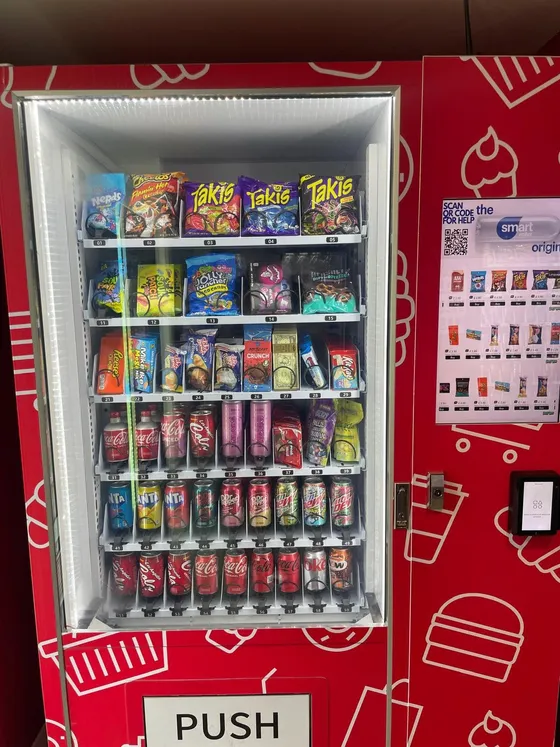 Well-stocked snack and drink vending machine with contactless payment