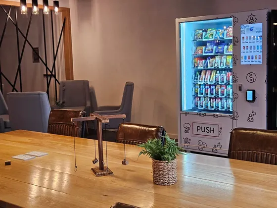 Patterned vending machine in a lounge area with seating