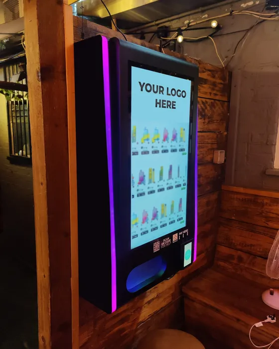JV100pro wall-mounted touchscreen lifestyle vending machine with purple LED edge lighting