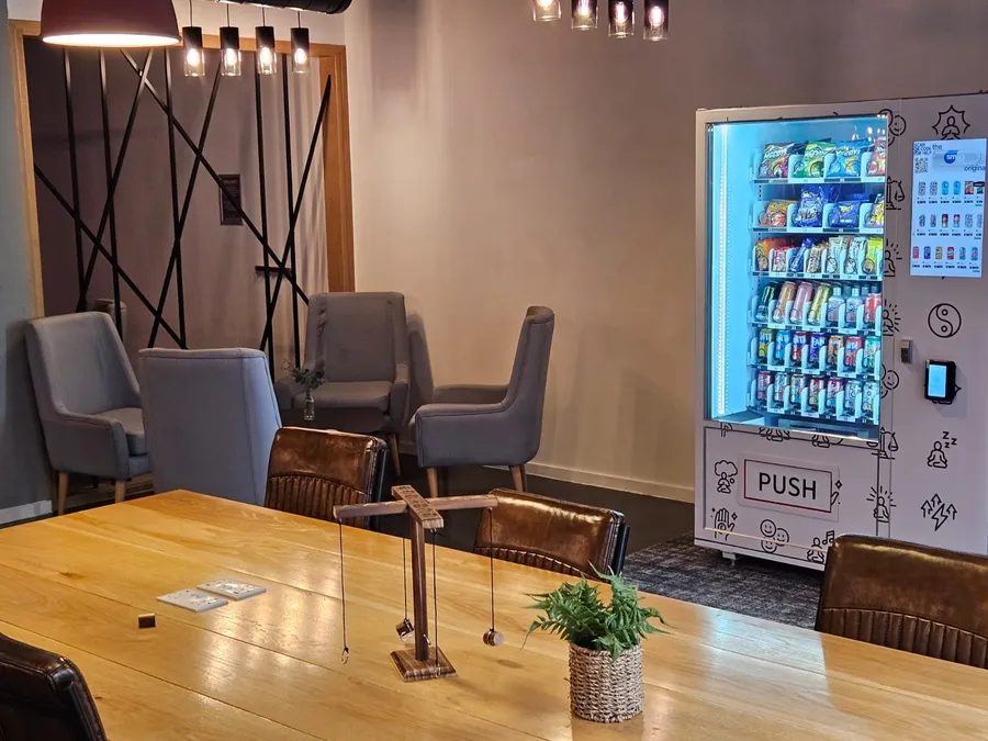 Snack and drink vending machine beside a quiet seating area