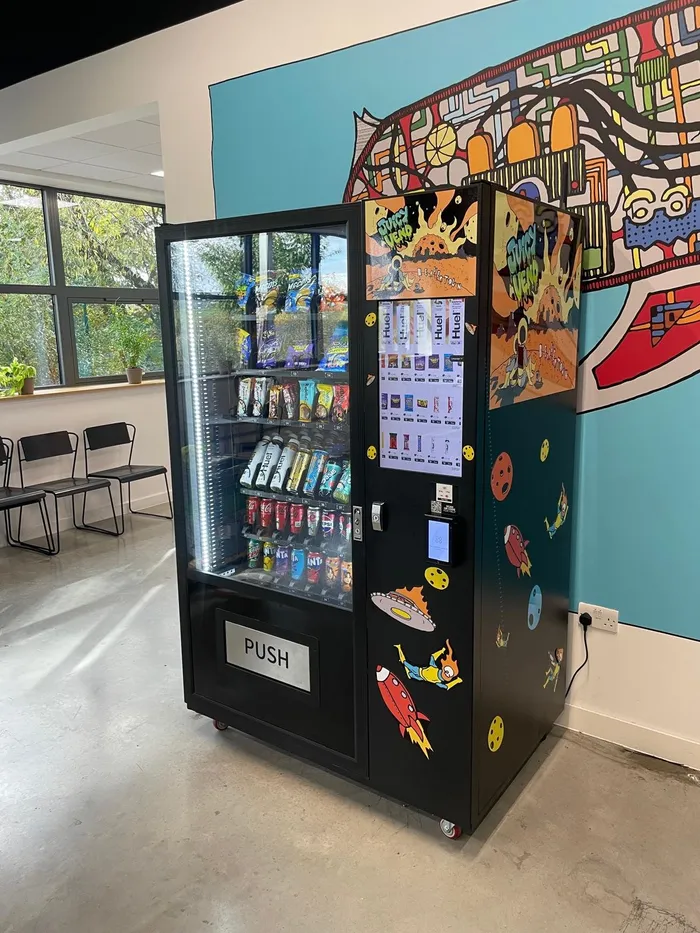 Custom mural-wrapped snack machine in an office