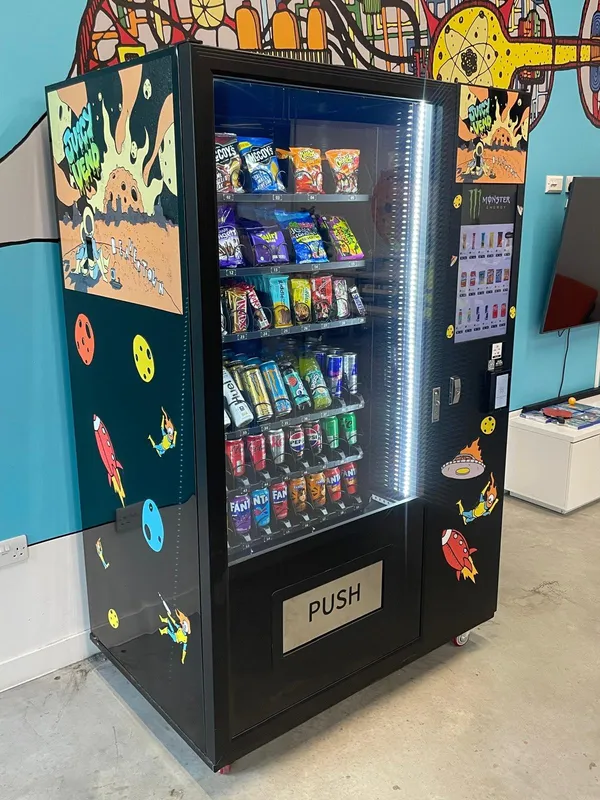 Close-up of a colourful mural-wrapped snack machine