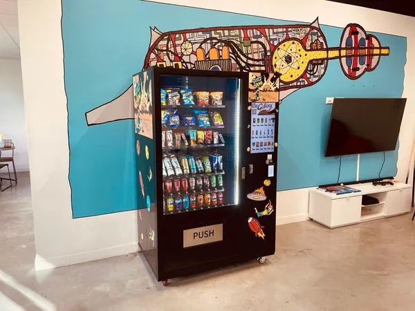 Office breakout area with a custom-wrapped machine and mural