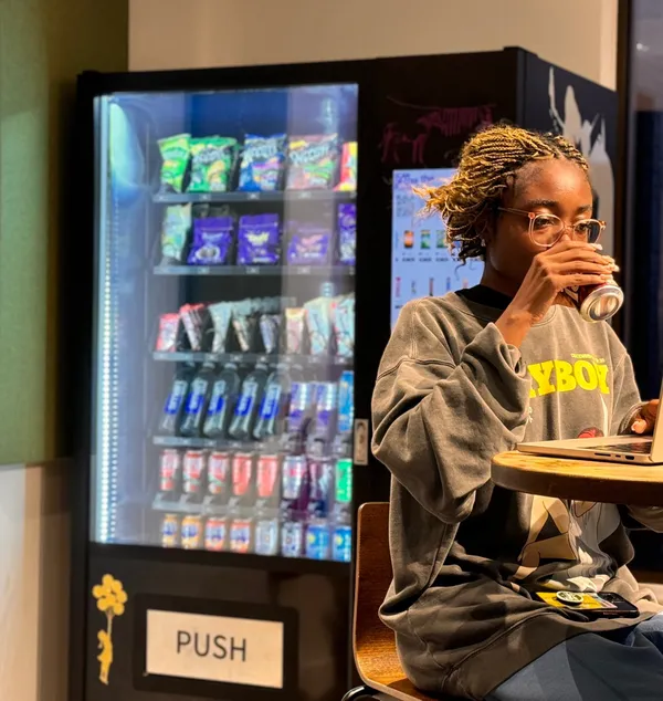 Enjoying a drink by a Juicy Vend machine at Rhodaus Court