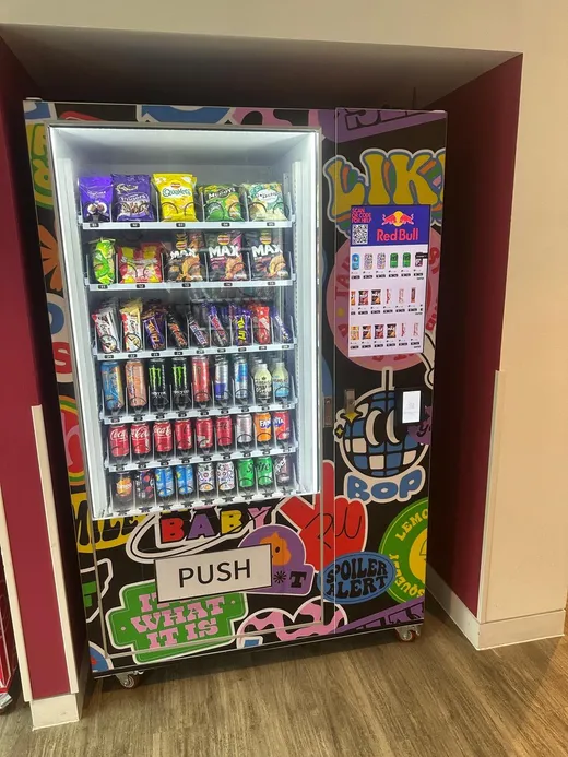 Purple graffiti-wrapped vending machine in student accommodation