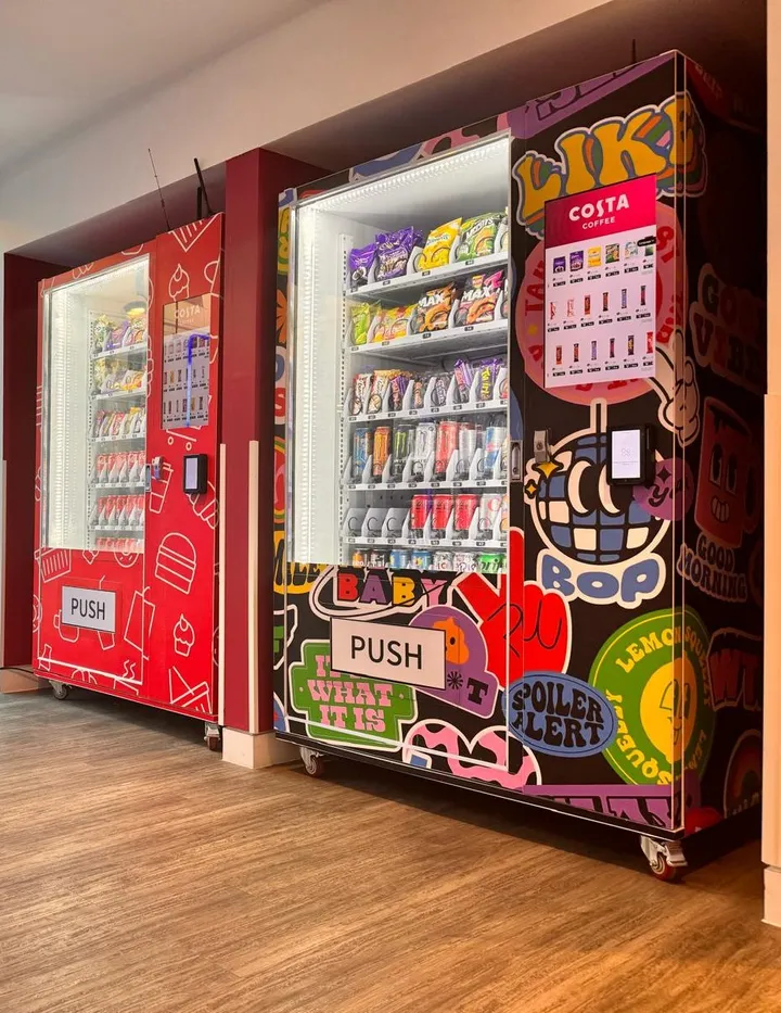 Two wrapped vending machines in a student common room