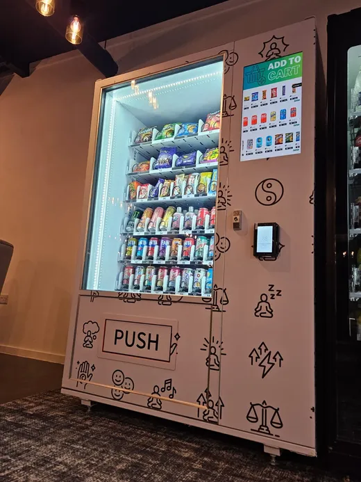 White vending machine with a hand-drawn pattern wrap